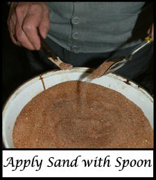 Apply sand with spoon